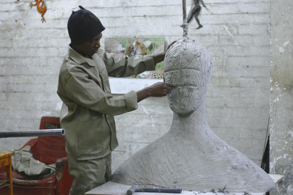 Stone carving tools and chisel work on sculpture in artist studio